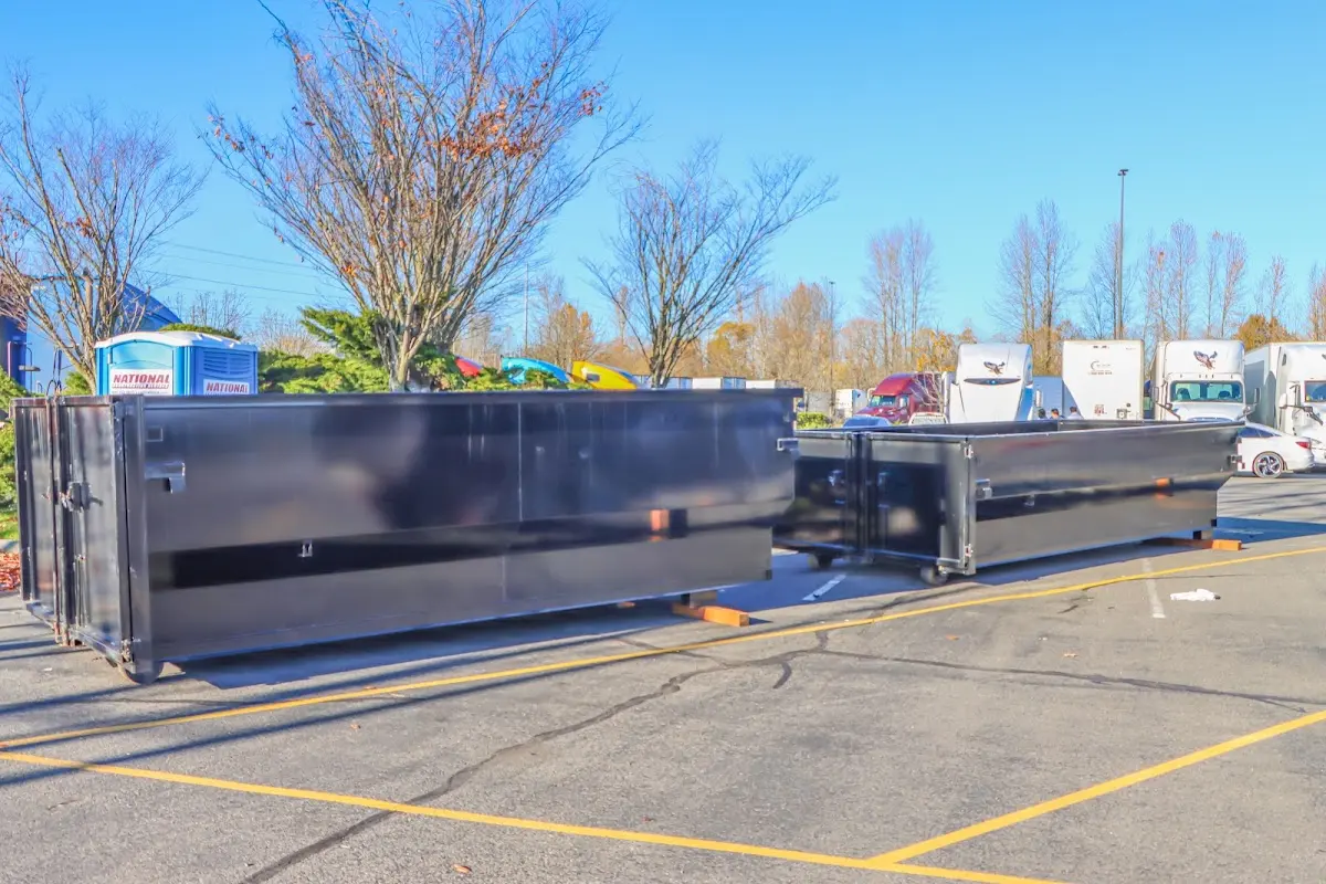 Professional dumpster rental service with roll-off container on residential driveway in Ridgeland